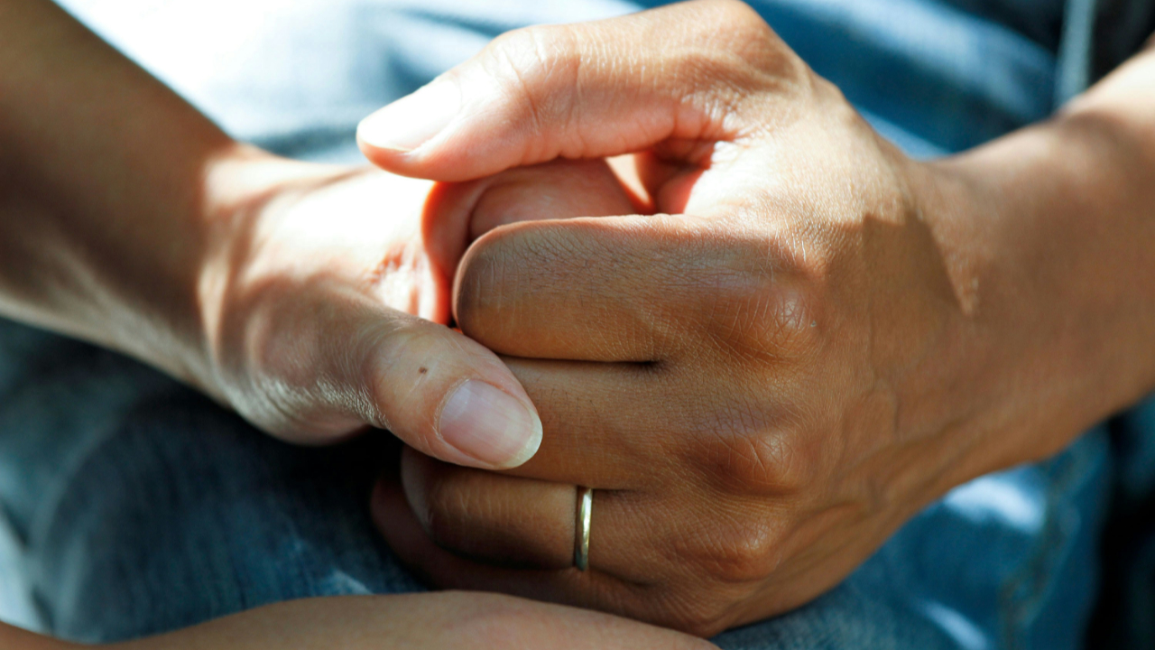 Person wearing gold wedding band by National Cancer Institute